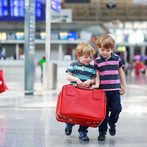 Two brother boys going on vacations trip at airport