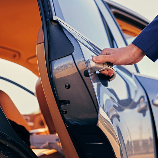 Close up image of a man opens car's door.